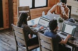 A group of young professionals working in a communal office coworking space