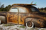 Photo of old, rusty car as a metaphor for the need to replace today’s leadership with new thinking. Politics. America. Progress. Change.
