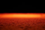 The surface of Mars glowing bright orange against the blackness of space