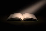 Ray of light on an open book