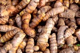 Piles of yellow and fresh turmeric root at the market display in Davao City, Philippines