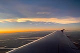 View from an airplane window during sunset