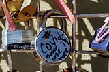 Picture of a lock on a gate that reads “COVID19 never lose hope”