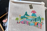 A photo of Pretty Little Hawaii Pattern by Satsuma Street cross stitch that’s half-finished.