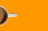 Mug of tea from above, set against an orange background