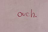 Writing on the wall that says ouch.