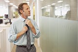 Man adjusting his tie.