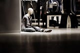 A store display mannequin sitting down, abandoned, to illustrate our sense of being controlled and abandoned by the world.