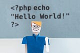 A code snippet saying “Hello world” with a paper doll of a programmer in front of it