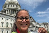 Photo of Kathy Flaherty smiling in front of the United States Capitol building.