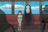 a little girl and a masked spirit sitting on a train