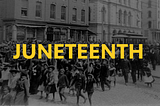 A picture of a Juneteenth Celebration in the past as Black people gather and join together in a march through town.