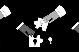 Hands fixing jigsaw puzzles with images of light bulbs on them together
