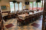 restaurant dining room with tables set up for large party