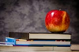 A photo of a red apple atop two