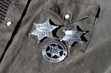 Three badges on a shirt