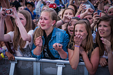 Crying teenage girls in the audience for a concert