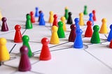 Colourful, plastic, game playing pieces arranged in a network.