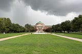 Building with copper dome on a dark, cloudy day