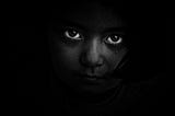 Child looking darkness all around, grayscale