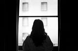 woman standing in front of a window