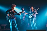 A three-piece rock combo jamming out in funky clothes.