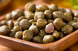 Photo of a wooden dish of Capers — What Are Capers?