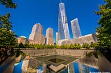 photo of One World Trade Center with the void of the Twin Towers in the foreground