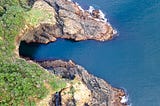 Rocky shoreline and ocean, seen from above