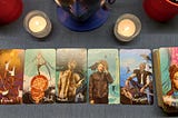 A tarot spread of five cards along with the bottom deck energy. Candles lit to clear the space of negativity and bring in clarity.