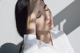 Stressed out woman dressed in white blouse