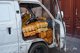 A white van is stuffed with hundreds of loaves of fresh-baked bread.