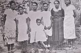 From right to left, Altagracia Joseph dressed in dark clothing, standing with Lydia Joseph Allen in the center and her granddaughters, born in Tela, Honduras.