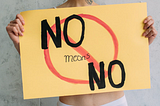 Person holding a sign that says “No Means No”