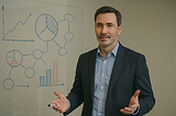 Business professional mapping out strategic solutions on a glass board