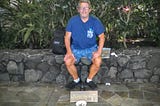 Joe sitting on a stone wall in Waikiki — Panhandling for Cannabis when I was Homeless