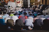 Muslims praying on Friday in Dubai. The congregation has spilled onto the road outside of the mosque.