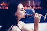 French woman drinking a glass of red wine