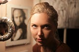 A portrait of a woman with a probing expression.