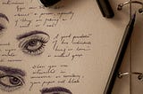 A photo of part of an open notepad depicting a mix of illustrated eyes and writing