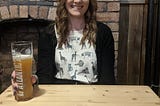 Rebecca Buggs, Outsource UK’s specialist recruiter, sitting at a wooden table with a pint