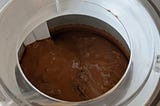 View from above of ice cream mix, just starting to churn, in a Cuisinart ICE-20 countertop ice cream freezer.