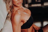 A woman flaunting her curves in a sexy black lingerie
