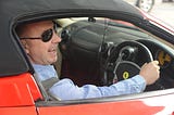 man in a ferarri car