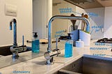 A photo of a kitchen counter with sink, goose-neck mixer tap and assorted utensils. Some of the items have been annotated.