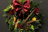 Christmas wreath with large red ribbon by Lavender Blue Florist