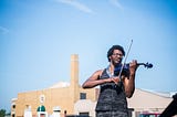 Violinist Christopher James plays at the Toledo Farmer’s Market.