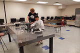 Ryan Swanson working with little boy on robot