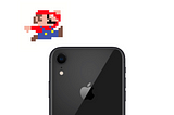Super Mario jumping over a sleek black iPhone
