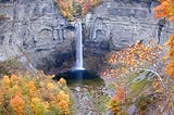 Photo of Taughannock Falls, autumn foliage accenting gray chasm walls.